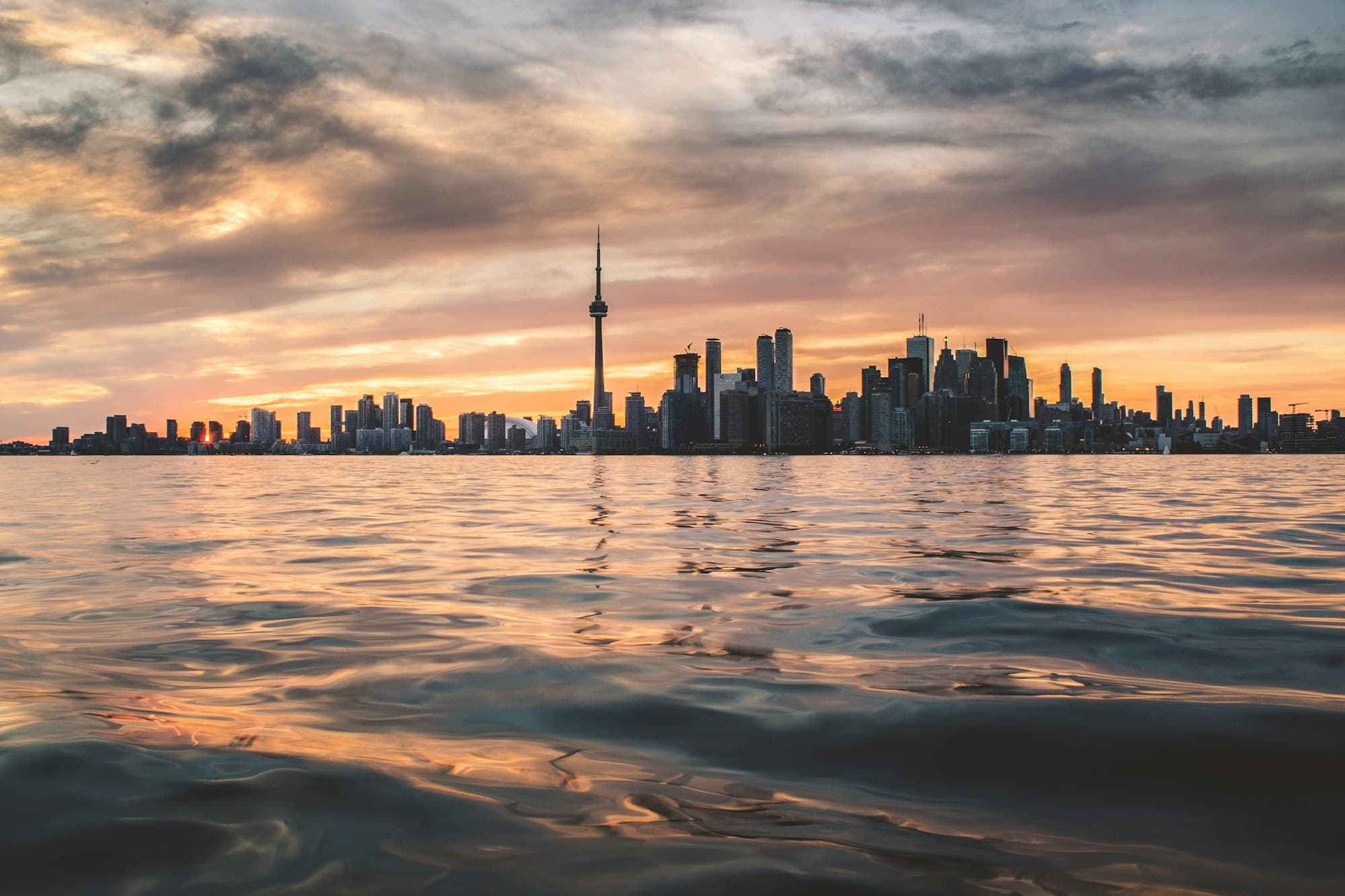 The Toronto skyline across Lake Ontario at dusk